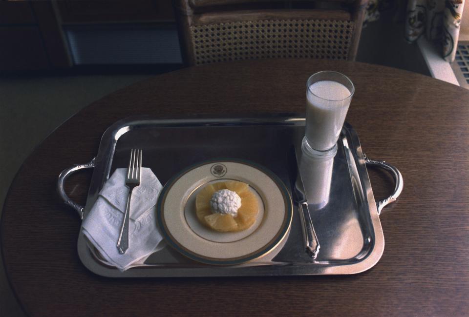 Pineapple, a dollop of cottage cheese on top, and milk on a tray