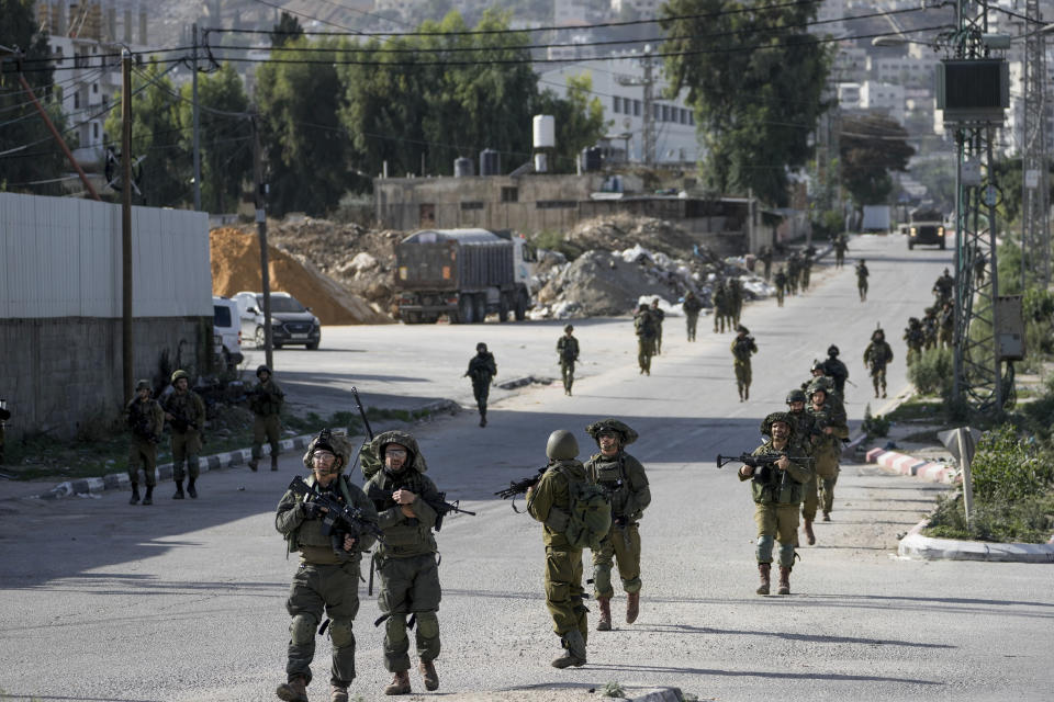 Israeli soldiers are seen in Balata, a Palestinian refugee camp in Nablus, West Bank, on Thursday, Nov. 23, 2023. (AP Photo/Majdi Mohammed)