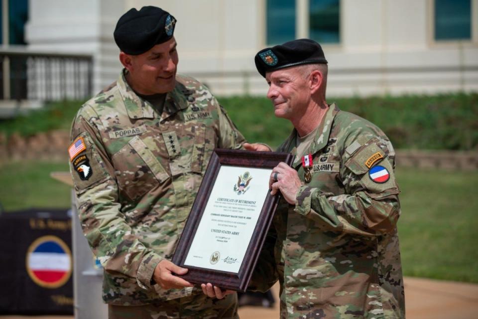 Gen. Andrew Poppas, the commanding general of United States Army Forces Command, presents Command Sgt. Maj. Todd W. Sims, the outgoing command sergeant major of FORSCOM, with the certificate of retirement following a change of responsibility ceremony Friday, Sept. 8, 20203, at the FORSCOM headquarters on Fort Liberty.