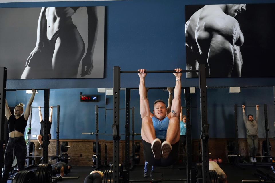 Scott Johnson, center right, participates in a fitness class at Lift Society Friday, May 21, 2021, in Studio City, Calif. California's top health official says the state no longer will require social distancing and will allow full capacity for businesses when the state reopens on June 15. (AP Photo/Marcio Jose Sanchez)