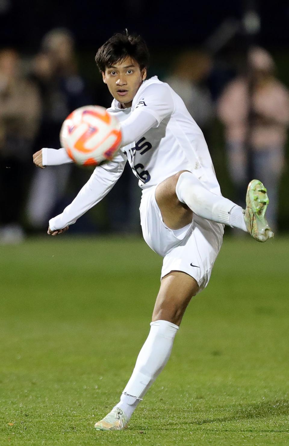 Akron midfielder Wan Kuzri Wan Kamal (16) sends the ball down the field during the second half of an NCAA soccer match against the Duquesne Dukes, Wednesday, Sept. 28, 2022, in Akron, Ohio.