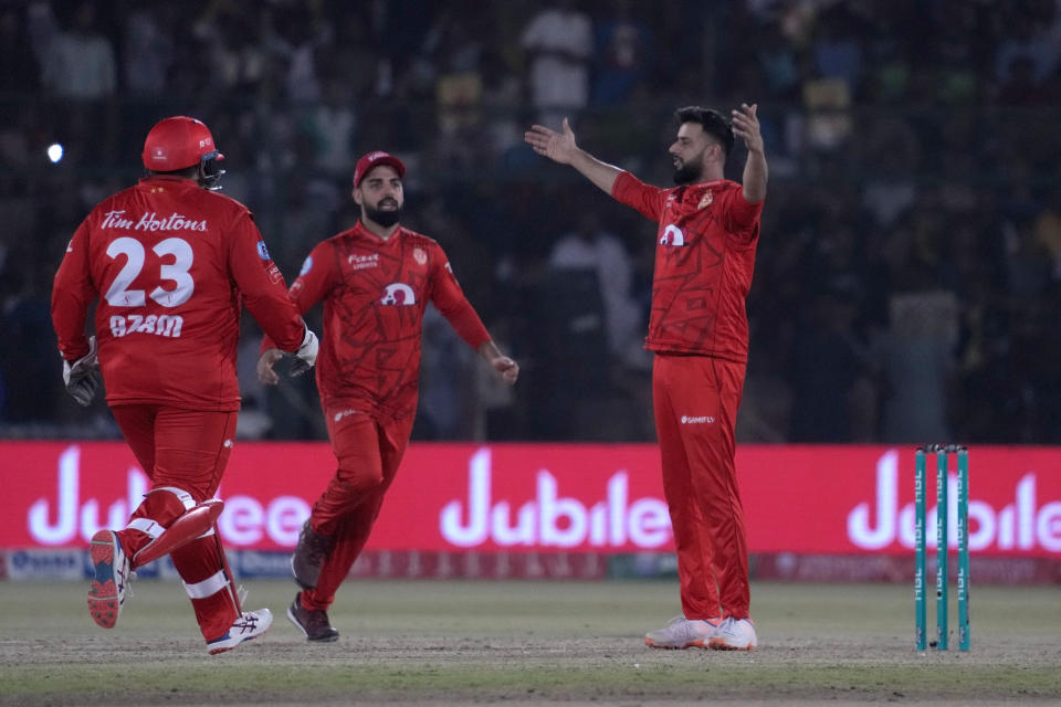 Islamabad United' Imad Wasim, right, celebrates with teammates after taking wicket during the final of Pakistan Super League T20 cricket match between Islamabad United and Multan Sultans, in Karachi, Pakistan, Monday March 18, 2024. (AP Photo/Fareed Khan)