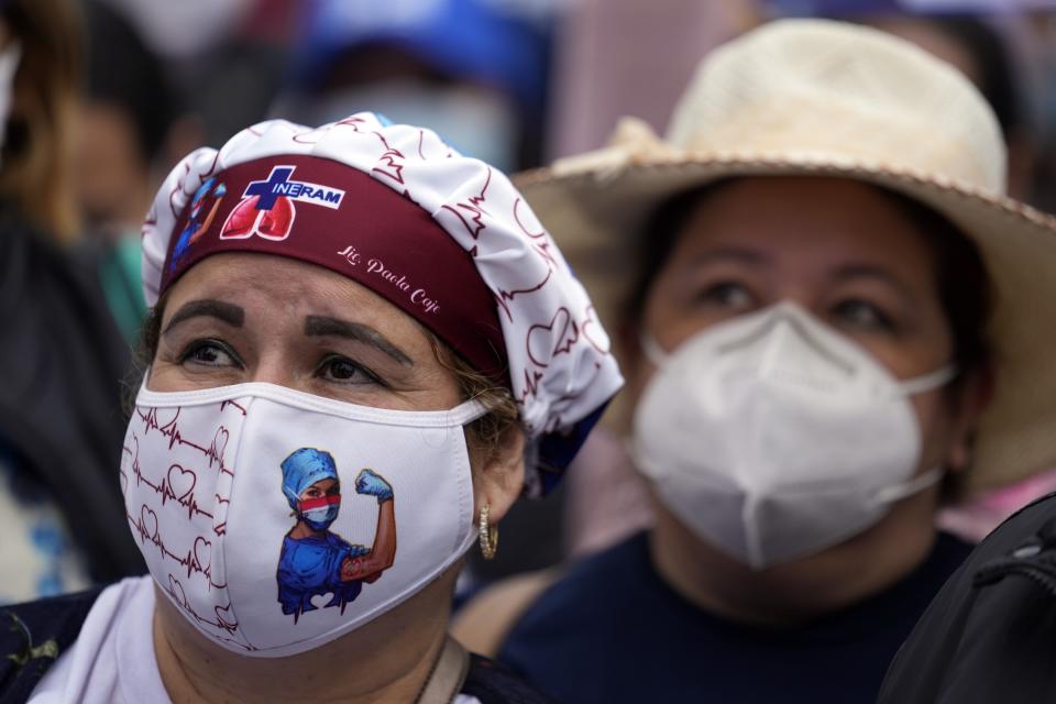 Nurse Paola Caje attends a march by public hospital nurses protesting for better salaries and the renewal of their temporary contracts amid the COVID-19 pandemic in Asuncion, Paraguay, Wednesday, Aug. 25, 2021. (AP Photo/Jorge Saenz)