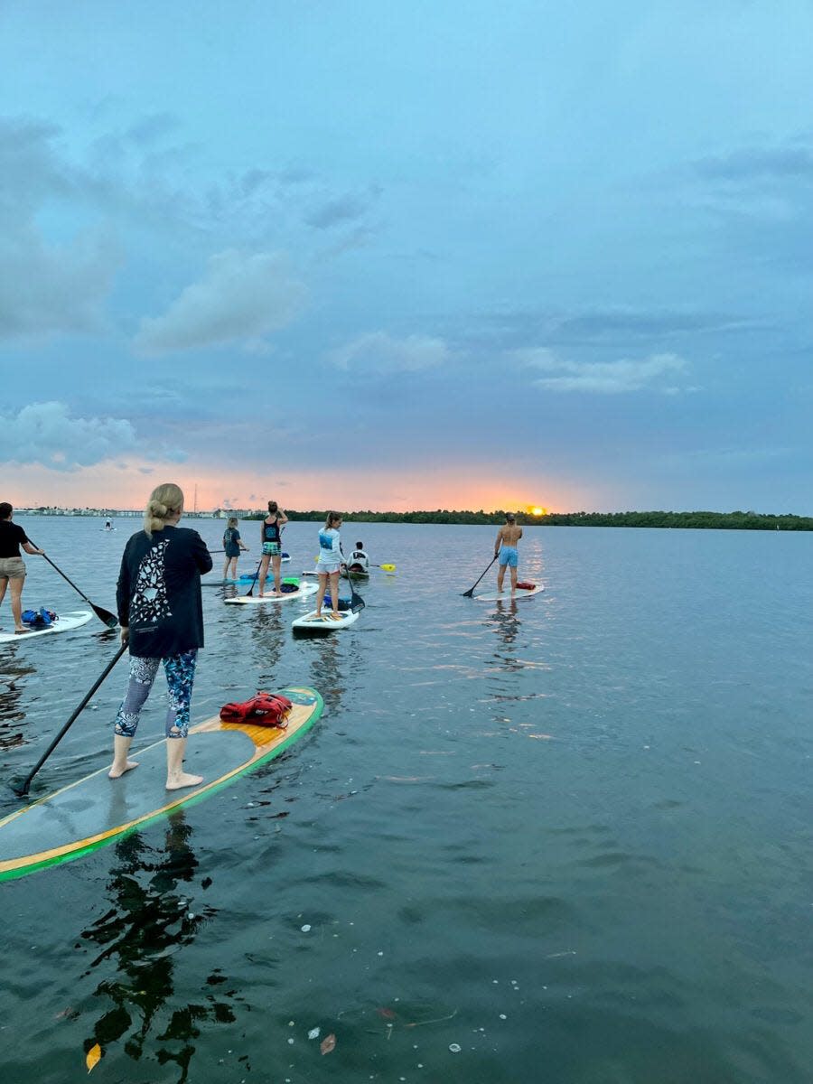 Participants watch the sun set during the MacBeach Moonlight Paddle excursion at MacArthur Beach State Park.