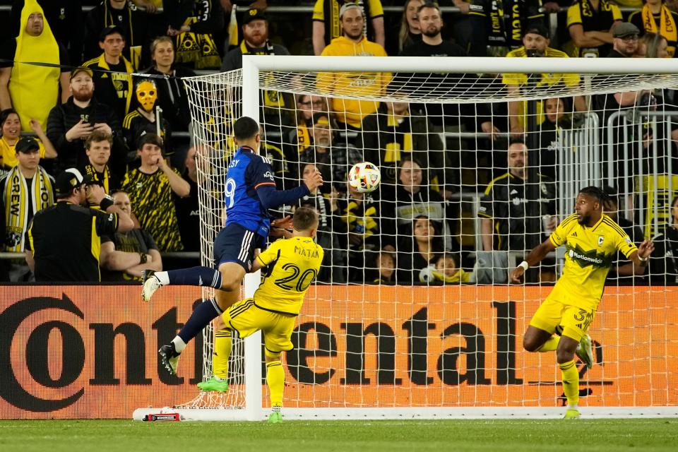 May 11, 2024; Columbus, OH, USA; FC Cincinnati defender Kevin Kelsy (19) scores a goal on a header over Columbus Crew midfielder Alexandru Matan (20) during the second half of the MLS soccer game at Lower.com Field. The Crew lost 2-1.