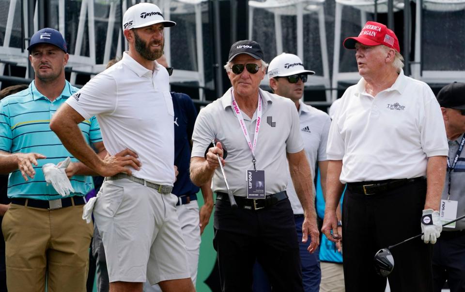 Donald Trump (right) with Greg Norman (second right), Dustin Johnson (second left) and Bryson DeChambeau (left) - AP