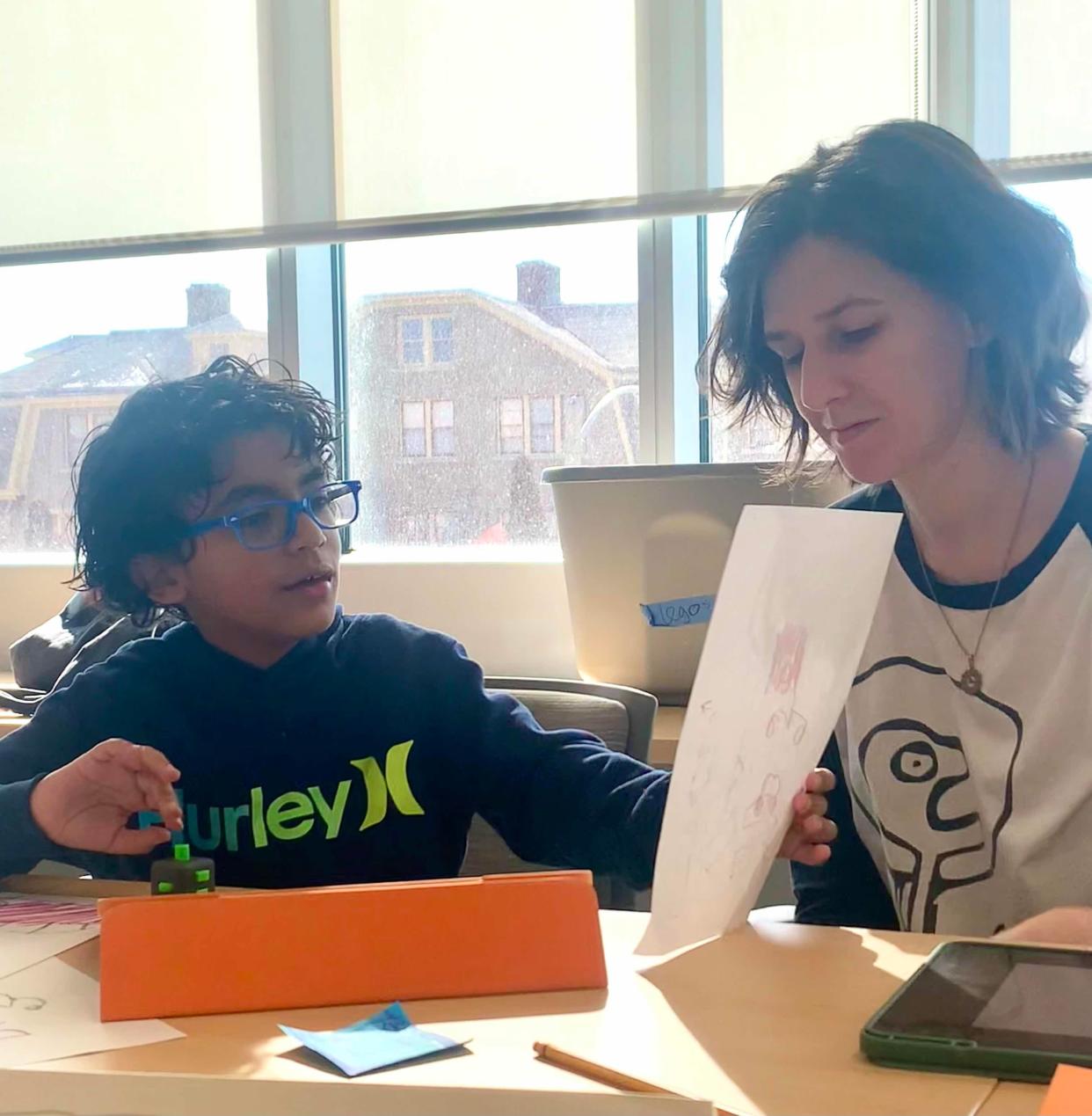 Islands of Brilliance student Julian works with his mentor, Tess, on a project. Islands of Brilliance pairs autistic students with mentors to create projects based upon the students' special areas of interest.