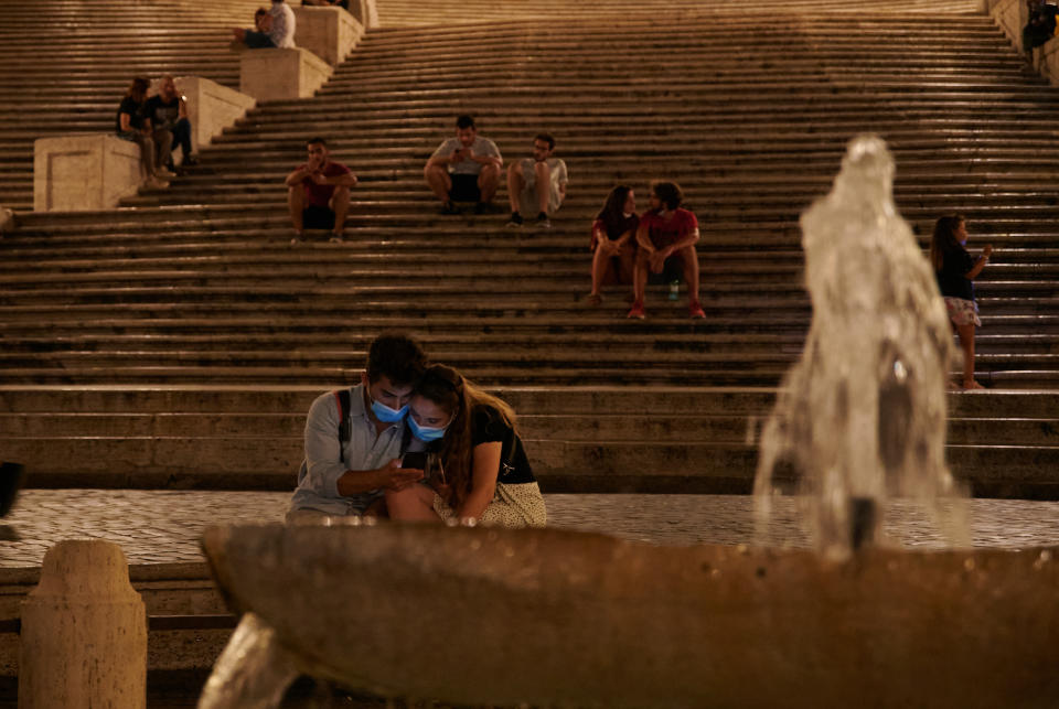 Una pareja con mascarillas en la Plaza de España en Roma. (Photo by Annette Riedl/picture alliance via Getty Images)