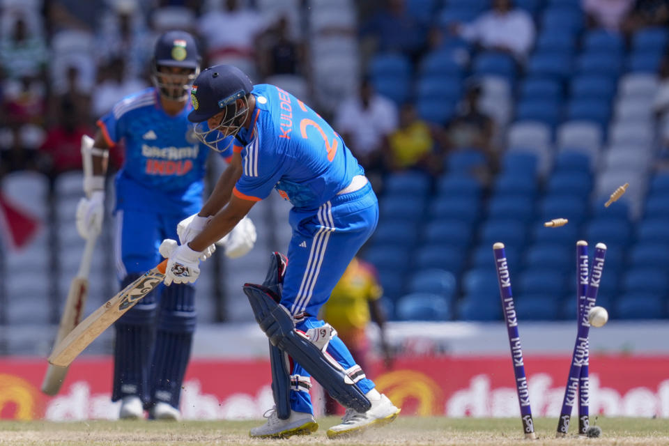 India's Kuldeep Yadav is bowled by West Indies' Romario Shepherd during their first T20 cricket match at the Brian Lara Stadium in Tarouba, Trinidad and Tobago, Thursday, Aug. 3, 2023. (AP Photo/Ramon Espinosa)