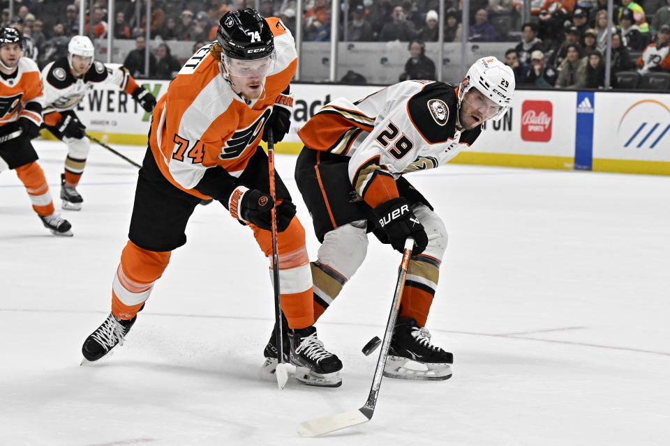 Anaheim Ducks defenseman Dmitry Kulikov, right, blocks a shot by Philadelphia Flyers right wing Owen Tippett during the first period of an NHL hockey game in Anaheim, Calif., Monday, Jan. 2, 2023. (AP Photo/Alex Gallardo)