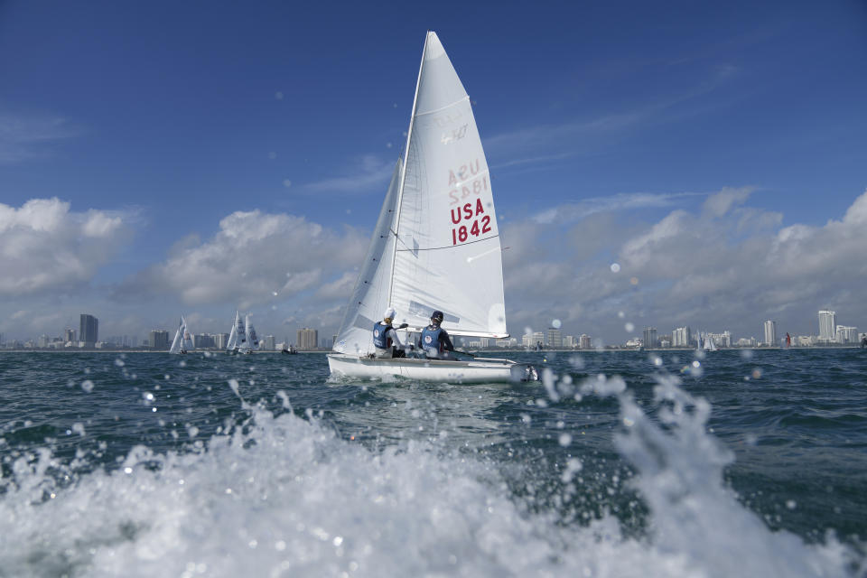 Lara Dallman-Weiss, left, and Stu McNay prepare to campaign in the mixed-gender 470 category at U.S. Sailing Olympic Trials, off the coast of Miami Beach, Fla., Friday, Jan. 12, 2024. McNay is returning for his fifth Olympics and teaming up with Dallman-Weiss, who competed in the women's 470 in the Tokyo Games, in the new mixed-gender category. (AP Photo/Rebecca Blackwell)