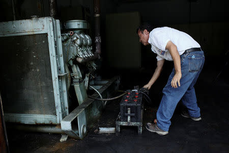 A worker tries to start the generator of the Padre Justo hospital during a blackout in Rubio, Venezuela March 14, 2018. Picture taken March 14, 2018. REUTERS/Carlos Eduardo Ramirez