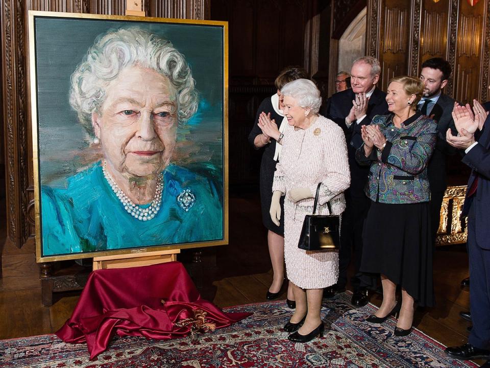 Queen Elizabeth II, Martin McGuinness, deputy first minister of Northern Ireland, and Frances Fitzgerald, Ireland’s minister of justice and equality, unveil a portrait of Queen Elizabeth II by artist Colin Davidson (Rex)