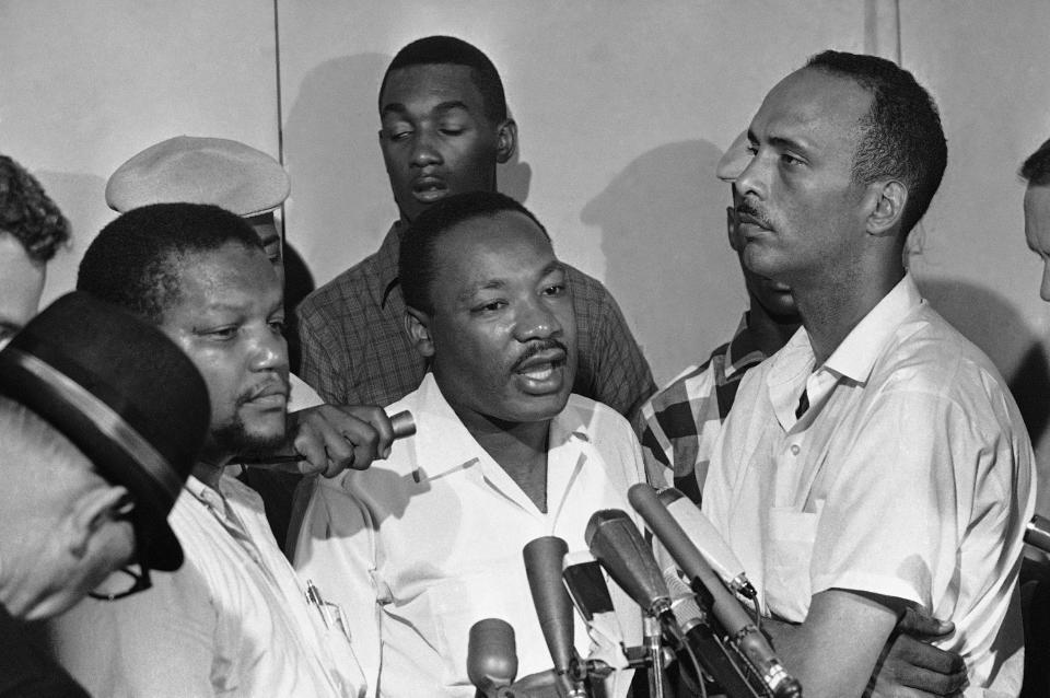 Dr. Martin Luther King Jr., center, said in a news conference that Chicago Mayor Richard Daley could do more "to deal with problems we confront in the Negro community" in Chicago on Aug. 13, 1966.  King asked for efforts to retain peace in the black Southwest Side where a disturbance started on Tuesday when police turned off a fire hydrant. With King are Chester Robinson, left, executive director of the Westside Organization and Al Raby, right, of the Coordinating Council of Community Organizations.