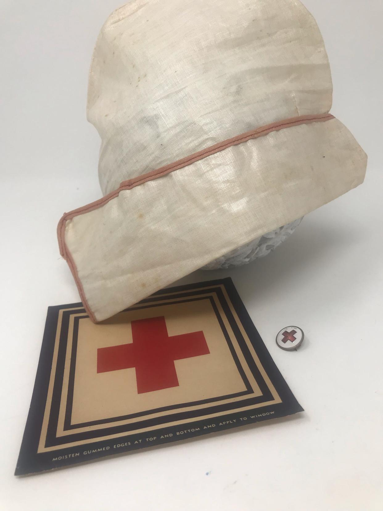 Among the items Andrea Chancellor's grandmother kept were a nursing cap and pin, and a Red Cross patch that was to be put in a window after donating to the Red Cross.