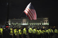 A supporter of President Donald Trump waves the U.S. flag outside Buckingham Palace in London, Tuesday, Dec. 3, 2019. Trump and his NATO counterparts were gathering in London Tuesday to mark the alliance's 70th birthday amid deep tensions as spats between leaders expose a lack of unity that risks undermining military organization's credibility. (AP Photo/Alberto Pezzali)