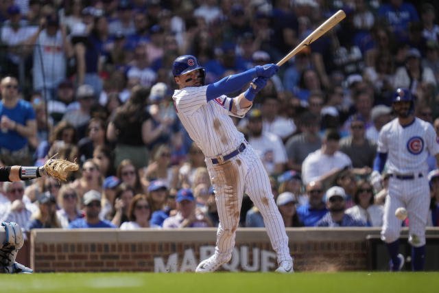 Chicago Cubs' Nico Hoerner, right, high-fives Chicago Cubs' Edwin