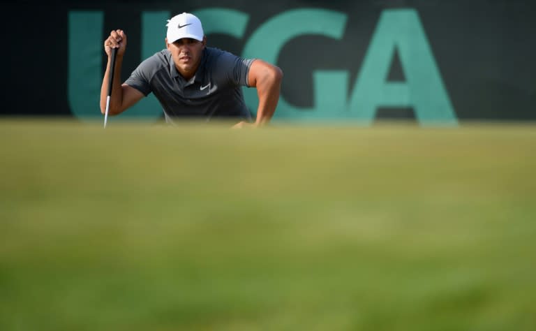 Brooks Koepka of the United States lines up a putt on the 15th green