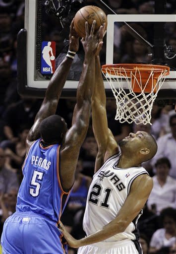 San Antonio Spurs center Tim Duncan (21) defends as Oklahoma City Thunder center Kendrick Perkins (5) shoots during the first quarter of Game 1 in their NBA basketball Western Conference finals playoff series, Sunday, May 27, 2012, in San Antonio. (AP Photo/Eric Gay)