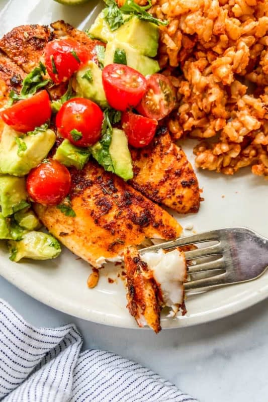 <p>This Healthy Table</p><p>This spicy blackened tilapia recipe is ready in minutes! The seasoning and sautéing of this dish combine to make a delicious, tender fish.</p><p><strong>Get the recipe: <a href="https://thishealthytable.com/blog/blackened-tilapia/" rel="nofollow noopener" target="_blank" data-ylk="slk:Blackened Tilapia;elm:context_link;itc:0;sec:content-canvas" class="link ">Blackened Tilapia</a></strong></p>