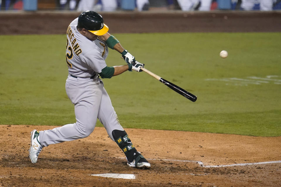 Oakland Athletics' Ramon Laureano swings for a two-run home run during the ninth inning of the team's baseball game against the Los Angeles Dodgers on Wednesday, Sept. 23, 2020, in Los Angeles. (AP Photo/Marcio Jose Sanchez)