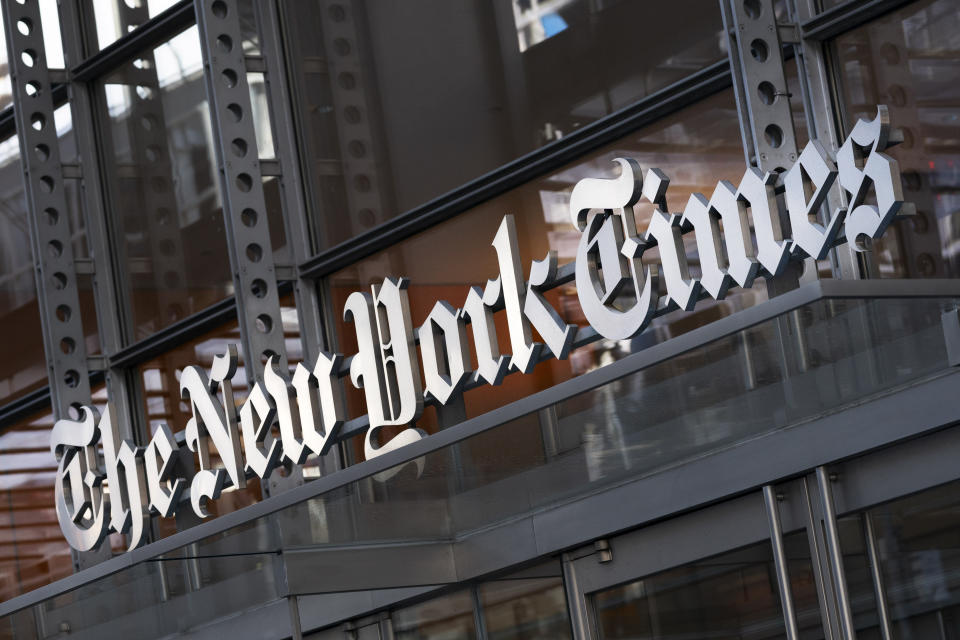 FILE - A sign for The New York Times hangs above the entrance to its building, Thursday, May 6, 2021 in New York. The New York Times moved swiftly to change the word fetus, Monday's answer to its daily Wordle puzzle, out of fear that it would be seen as some sort of commentary on the debate over abortion rights. The game, which became a sensation late last year and was bought by The Times in January, gives users six tries to guess a different five-letter word each day. (AP Photo/Mark Lennihan, File)