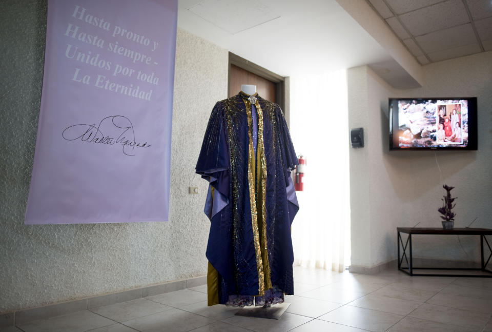 A cape worn by the late television astrologer Walter Mercado is on display during a public wake in the Santurce neighborhood, San Juan, Puerto Rico, Wednesday, Nov. 6, 2019. Mercado, whose glamorous persona made him a star in Latin media and a cherished icon for gay people in most of the Spanish-speaking world, died Saturday. He was 88. (AP Photo/Carlos Giusti)