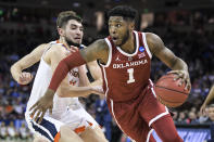 Oklahoma guard Rashard Odomes (1) drives past Virginia guard Ty Jerome (11) during the first half of a second-round game in the NCAA men's college basketball tournament Sunday, March 24, 2019, in Columbia, S.C. (AP Photo/Sean Rayford)