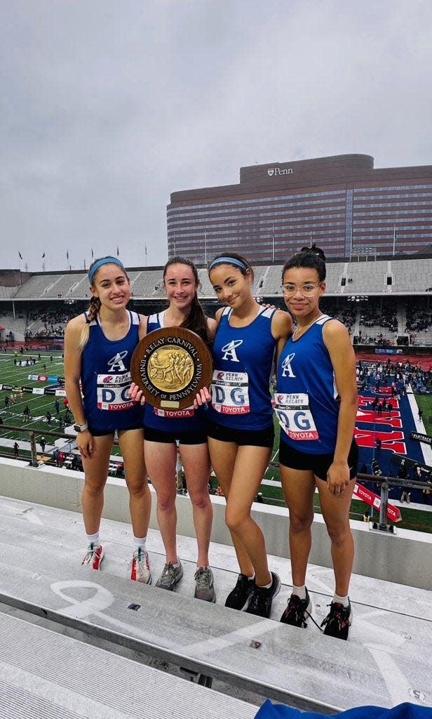 Holy Angels 4-x-400 team poses with their Penn Relays first place wheel.
(Photo: Courtesy Holy Angels track and field)