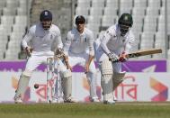 Cricket - Bangladesh v England - Second Test cricket match - Sher-e-Bangla Stadium, Dhaka, Bangladesh - 30/10/16. Bangladesh's Shakib Al Hasan (R) plays a shot as England's wicketkeeper Jonathan Bairstow (L) and Joe Root look on. REUTERS/Mohammad Ponir Hossain