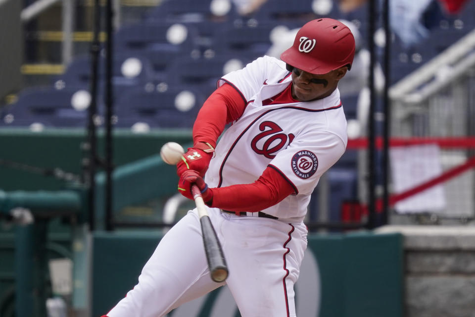 Washington Nationals' Juan Soto hits a sacrifice fly during the fourth inning of a baseball game against the Arizona Diamondbacks at Nationals Park, Saturday, April 17, 2021, in Washington. (AP Photo/Alex Brandon)