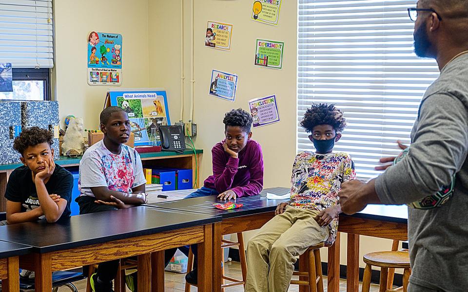 Mark James Jr. speaks with students in a classroom at The Webster School in West Augustine, where he volunteers, on Friday, Dec. 3, 2021. James,  a corrections officer for the St. Johns County Sheriff's Office, is a finalist for USA TODAY'S inaugural Best of Humankind awards.