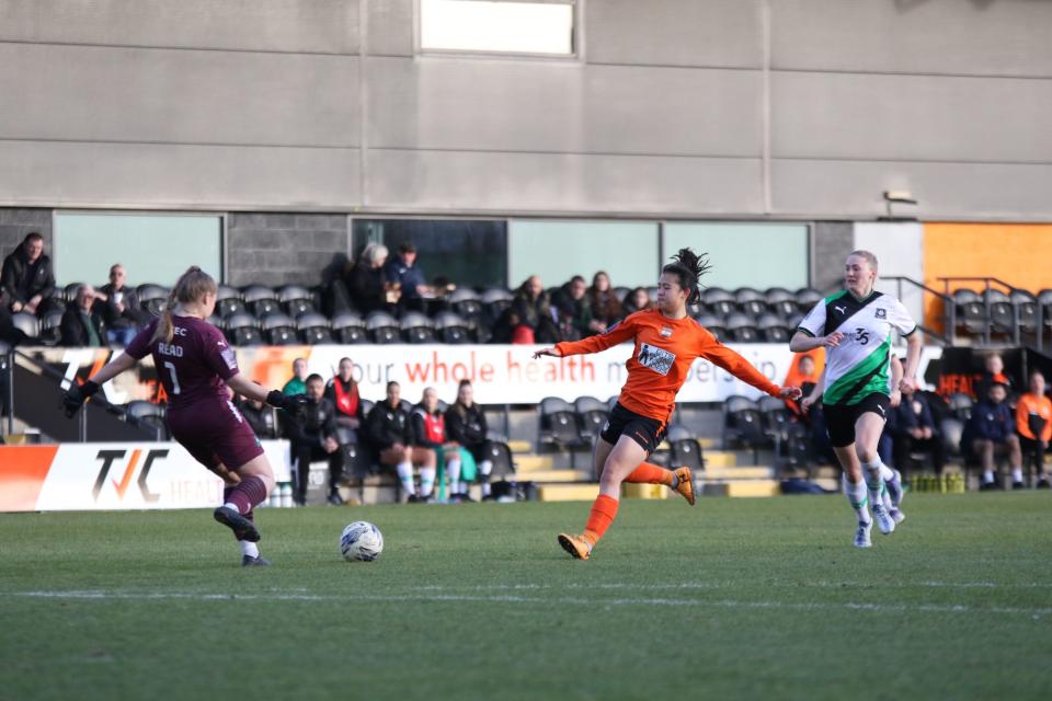 Singapore national women's footballer Danielle Tan (orange jersey) in action for London Bees in their league match against Plymouth Argyle. (PHOTO: FAS)