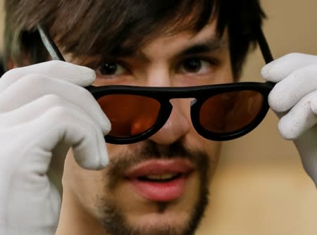 Havrylenko, CEO of innovative OCHIS COFFEE eyewear brand, shows an eco-friendly sunglasses, made of coffee waste, in his workshop ner Kiev