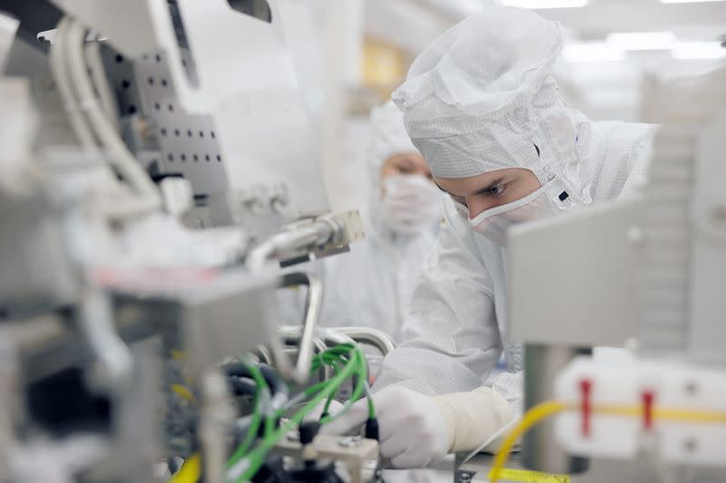 An engineer assembles part of a High NA EUV tool at ASML’s headquarters in Veldhoven