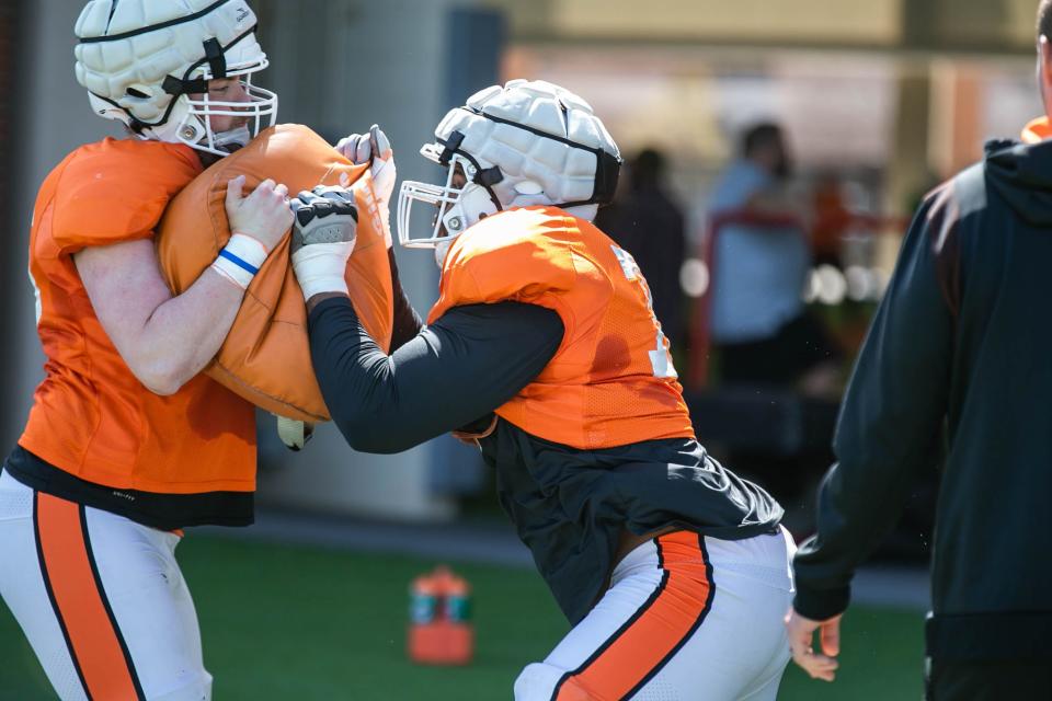 Redshirt junior Caleb Etienne, right, is in line to start at left tackle for Oklahoma State this season.
