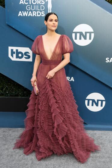 Emily Hampshire arrives at the SAG Awards in a long ruffled gown