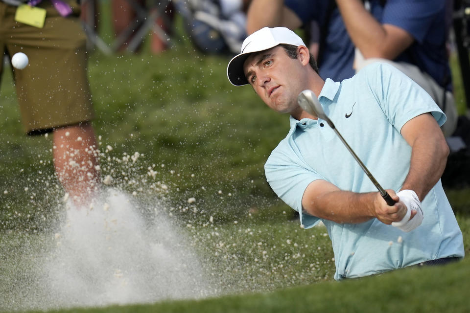 Scottie Scheffler hits from a bunker toward the 16th green during the final round of The Players Championship golf tournament, Sunday, March 12, 2023, in Ponte Vedra Beach, Fla. (AP Photo/Charlie Neibergall)