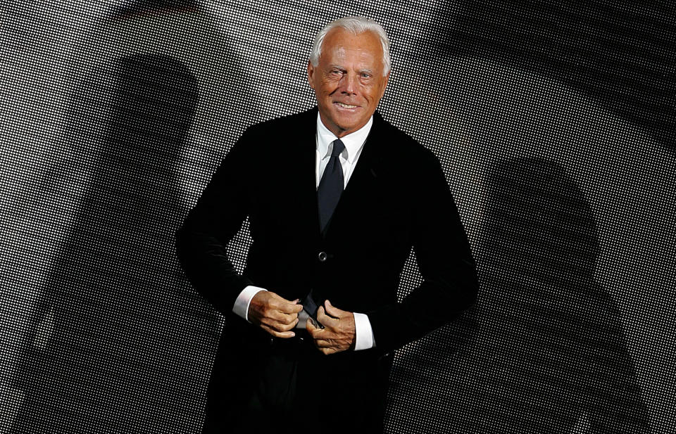 Italian designer Giorgio Armani acknowledges the applause at the end of his Fall/Winter 2006/2007 men's collection fashion show during Milan Fashion Week January 19, 2006. REUTERS/Max Rossi Pictures of the Month January 2006