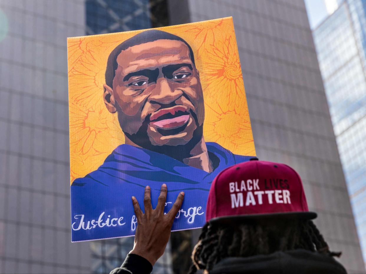 <p>In this file photo demonstrators hold signs honouring George Floyd and other victims of racism as they gather during a protest outside Hennepin County Government Centre on 28 March 2021 in Minneapolis, Minnesota</p> ((AFP via Getty Images))