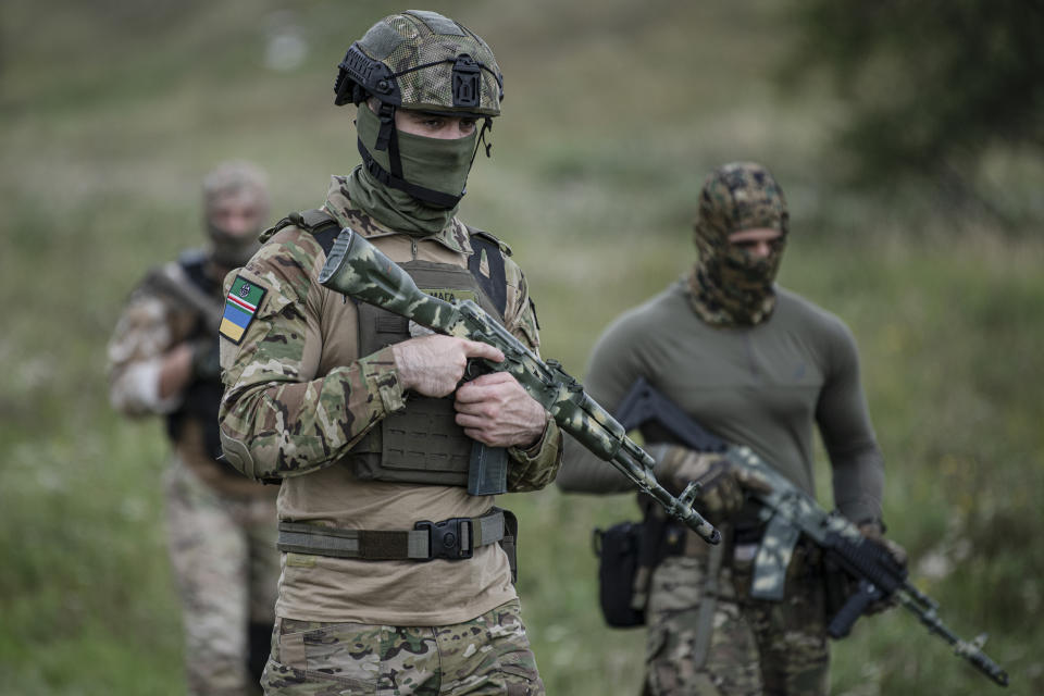 Volunteer soldiers attend a training outside Kyiv, Ukraine, Saturday, Aug. 27, 2022. Some volunteers signed up to join a Chechen unit that fights alongside the Ukrainian military. Fighters from Chechnya, the Russian republic in the North Caucasus, are participating on both sides of the conflict in Ukraine, with pro-Kyiv volunteers loyal to Dzhokhar Dudayev, the late Chechen leader who headed the republic's drive for independence from Russia. (AP Photo/Andrew Kravchenko)