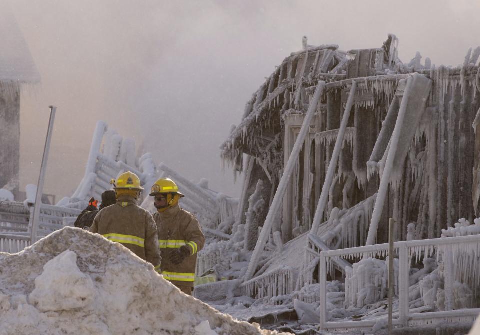 Firefighters work at the scene of a senior's residence fire on Thursday, Jan. 23, 2014 in L'Isle-Verte, Quebec. The fire raged through the seniors' residence, killing at least three people and leaving about 30 unaccounted for. The massive fire in the 52-unit complex broke out around 12:30 a.m. in L'Isle-Verte, about 140 miles (225 kilometers) northeast of Quebec City. (AP Photo/The Canadian Press, Jacques Boissinot)