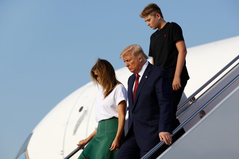 President Donald Trump steps off Air Force One with first lady Melania Trump and son Barron Trump at Andrews Air Force Base, Md., Sunday, August 18, 2019, after a vacation at his golf club in New Jersey. (AP Photo/Patrick Semansky) ORG XMIT: OTK