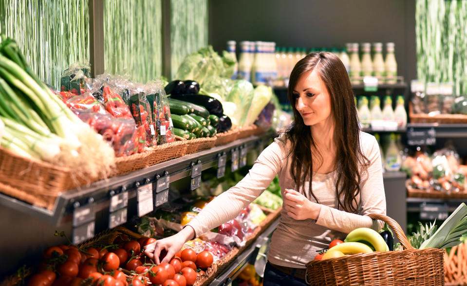 young pretty woman shopping for fresh healthy food in the supermarket