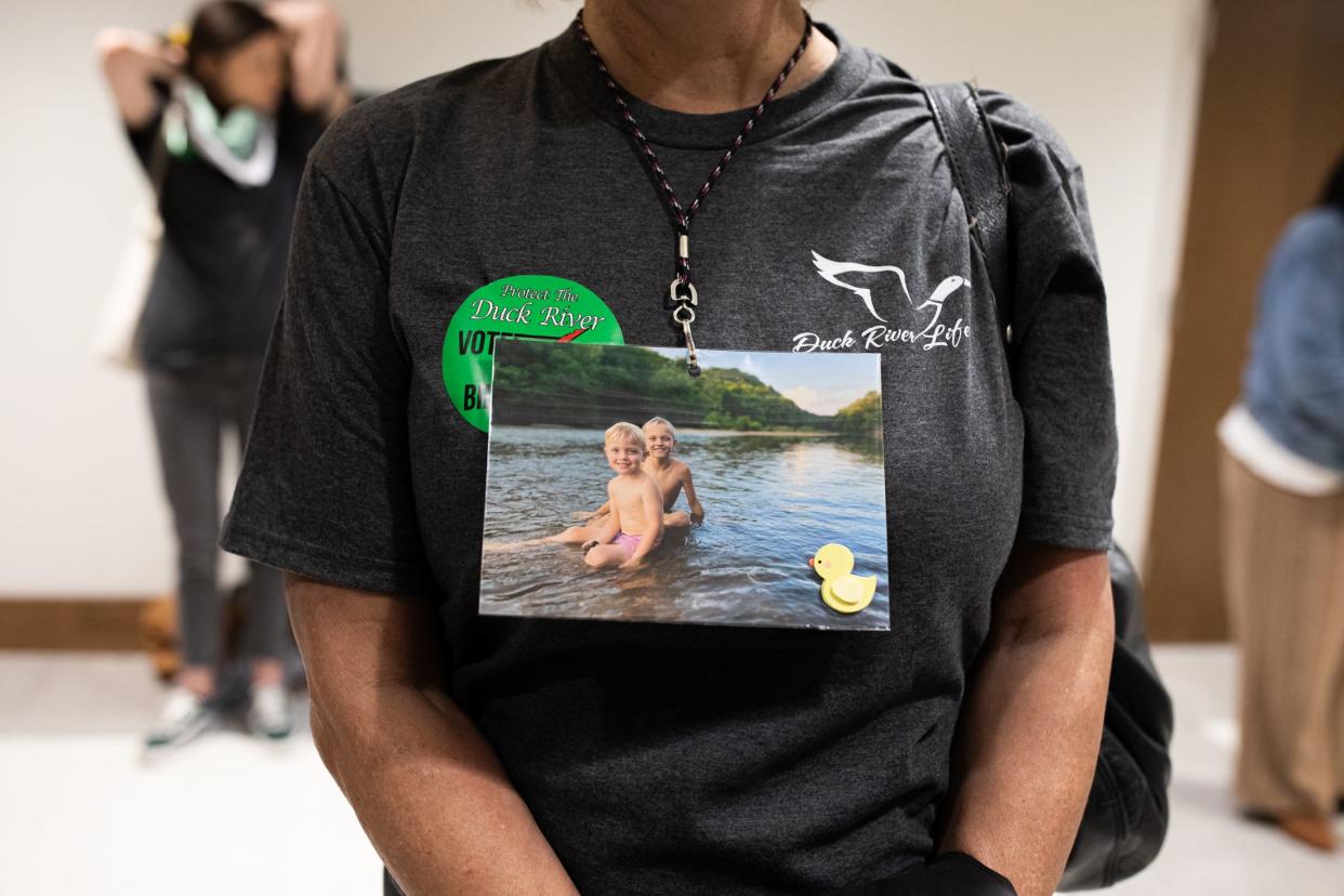 A Maury County resident advocates to protect clean water in the Duck River by wearing a lanyard showing her family playing in the river. She attends a House Agriculture & Natural Resources Committee meeting at the Cordell Hull building in Nashville on March 15, 2023.