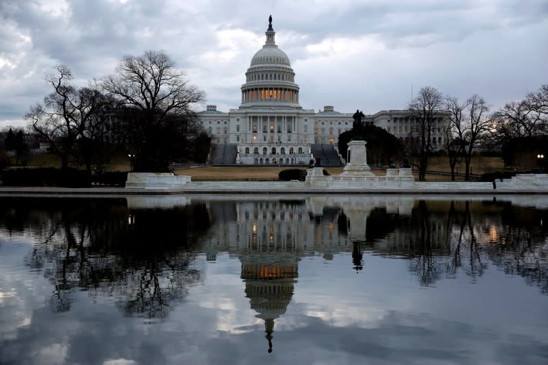 FILE PHOTO: Clouds pass over the U.S. Capitol at the start of the third day of a shut down of the federal government in Washington