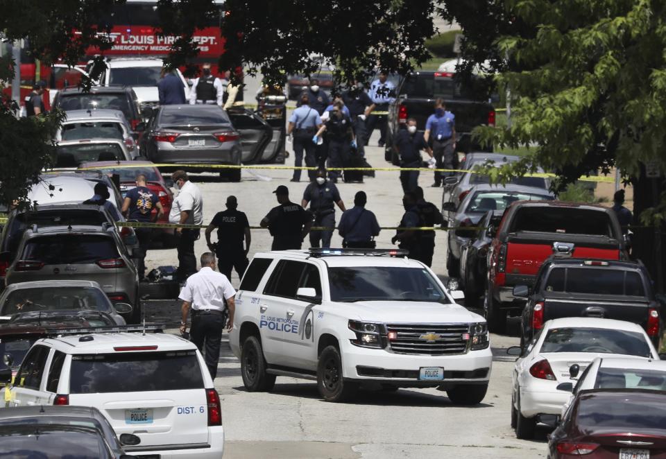 Police work on the scene of a shooting Wednesday, July 29, 2020, in the Walnut Park West neighborhood of north St. Louis. Police received multiple reports of a shooting and officers found several victims suffering from gunshot wounds. It wasn't clear what prompted the gunfire but authorities said it stemmed from a dispute between two groups. (David Carson/St. Louis Post-Dispatch via AP)