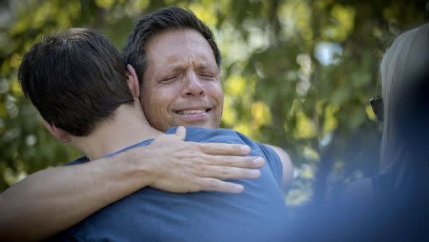 Justine's partner, Don Damond, is comforted after the fatal shooting. Source: AAP