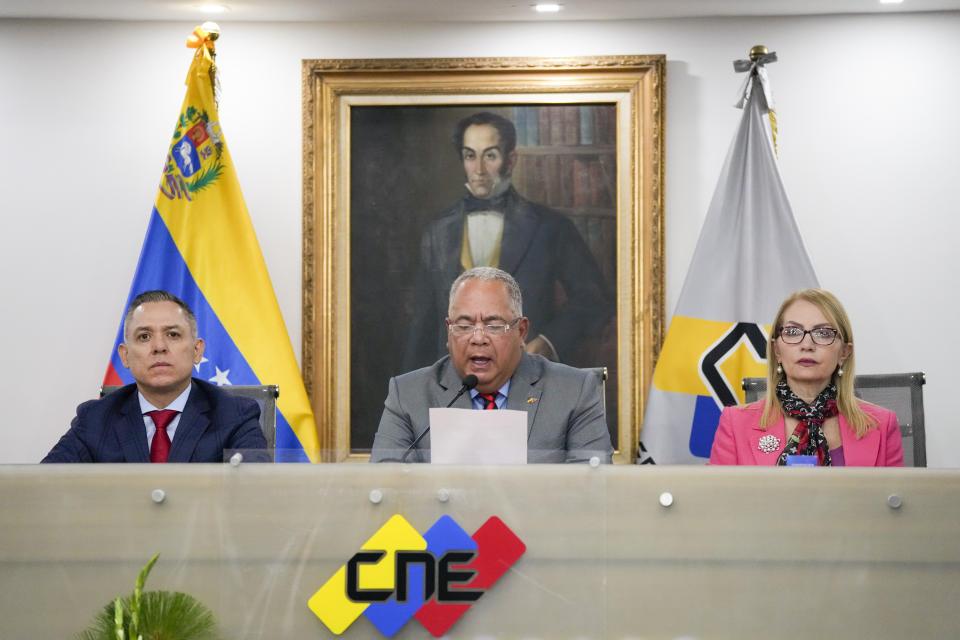 FILE - National Electoral Council (CNE) President Elvis Hidrobo Amoroso, center, speaks to the press at the National Electoral Council headquarters, flanked by Carlos Enrique Quintero, left, and Rosalba Gil, in Caracas, Venezuela, March 5, 2024. Amoroso announced that Venezuela's presidential election will take place on July 28. (AP Photo/Ariana Cubillos, File)