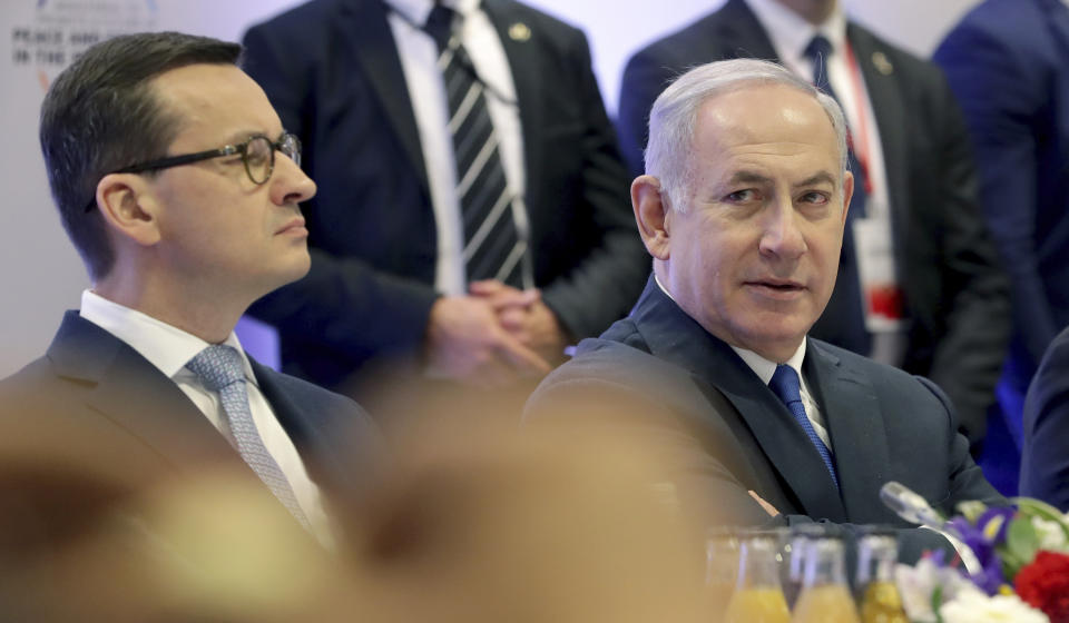 File -- In this Thursday, Feb. 14, 2019 photo Poland's Prime Minister Mateusz Morawiecki, left, and Israeli Prime Minister Benjamin Netanyahu, right, attend a meeting in Warsaw, Poland. Poland's prime minister canceled plans for his country to send a delegation to meeting in Jerusalem on Monday after the acting Israeli foreign minister Israel Katz said that Poles "collaborated with the Nazis" and "sucked anti-Semitism from their mothers' milk". (AP Photo/Michael Sohn)